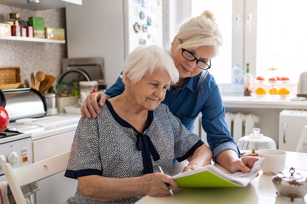 Woman helping her mother with paperwork